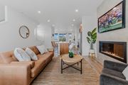 Camas townhouse for rent - Living room with a fireplace and a television at Thrive at Green Mountain, Camas