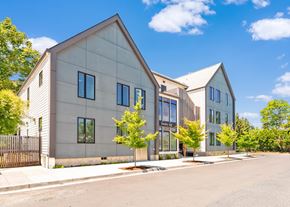 Portland apartment for rent - A modern house with a grey exterior and a black gate at Society 62 Apartments, Portland, Oregon