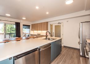 Portland apartment for rent - A modern kitchen with stainless steel appliances and wooden cabinets at Society 62 Apartments, Portland, OR