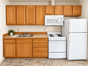 Portland apartment for rent - A kitchen with white appliances and wooden cabinets.