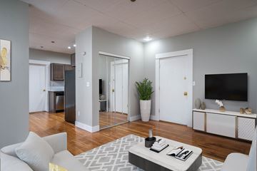 Portland apartment for rent - A modern living room with a grey sofa and a grey coffee table.