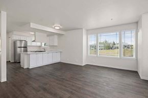 Tacoma townhouse for rent - an empty kitchen and living room with a large window