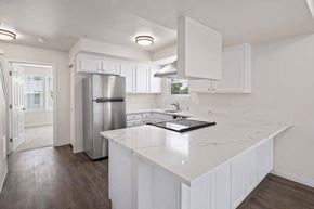 Tacoma townhouse for rent - a kitchen with a white counter top and a refrigerator