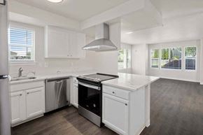 Tacoma townhouse for rent - a kitchen with a stove top oven next to a sink