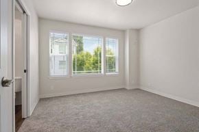 Tacoma townhouse for rent - a bedroom with three windows and a door