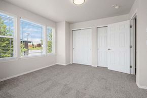 Tacoma townhouse for rent - a bedroom with three windows and a door