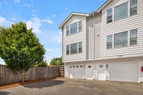 Tacoma townhouse for rent - a white house with two garages in front of it