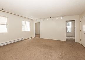 Portland apartment for rent - A large empty room with carpeted floor and white walls.