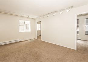 Portland apartment for rent - A large, empty room with carpeted floors and white walls.