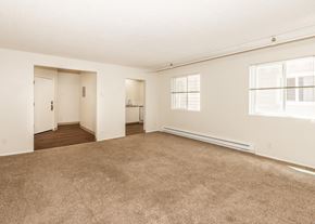 Portland apartment for rent - A large, empty room with carpeted flooring and white walls.