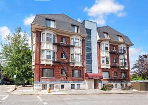 Portland apartment for rent - A red brick building with a black metal fire escape.