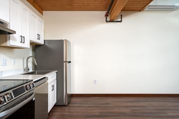 Portland apartment for rent - A kitchen with a stove top oven and a refrigerator.
