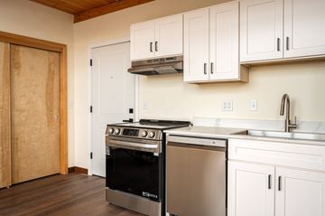 Portland apartment for rent - A modern kitchen with a stainless steel oven and white cabinets.