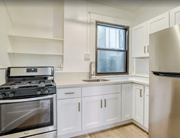 Portland apartment for rent - A modern kitchen with a stove, sink, and refrigerator.