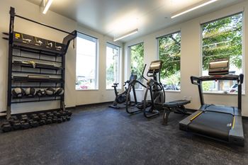 Gym with exercise equipment and windows at the district flats apartments in lenexa