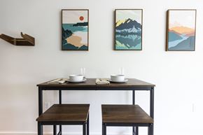 Portland apartment for rent - a dining room with three tables and three paintings on the wall at Shift, Portland Oregon