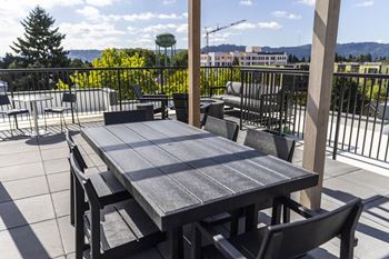 A patio with a table and chairs on a balcony
