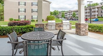 A patio with a table and chairs