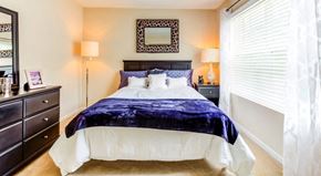 Greenville apartment for rent - a bedroom with a large bed and a window with blinds at The Bristol Apartments, Greenville