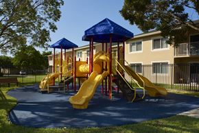 Homestead apartment for rent - a childrens playground in front of an apartment building