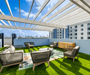 Miami apartment for rent - A patio with a white roof and a green lawn.
