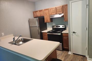Clearwater apartment for rent - A kitchen with a stove, sink, and cabinets.