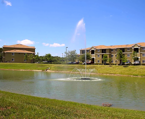Ellenton apartment for rent - a fountain in the middle of a lake with apartment buildings in the background