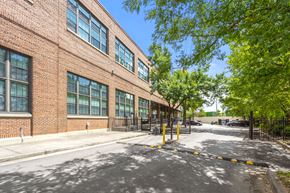 Atlanta apartment for rent - A red brick building with a black gate in front.