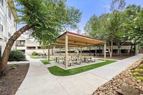 Atlanta apartment for rent - A covered picnic area with benches is surrounded by trees.