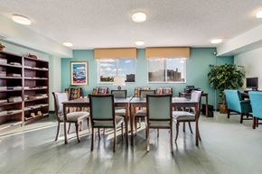 Miami apartment for rent - a dining room with a table and chairs and a bookshelf
