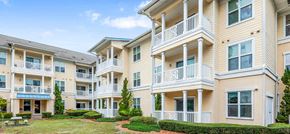 Port Richey apartment for rent - a row of apartments with balconies and a yard