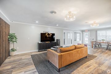 Goose Creek apartment for rent - A living room with a brown sofa and a television.