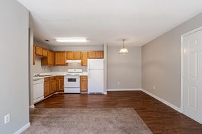 Travelers Rest apartment for rent - A kitchen with white appliances and wooden cabinets.at Brookside Pointe Apartments, Travelers Rest, 29690