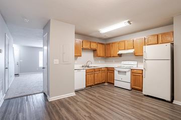 Travelers Rest apartment for rent - A kitchen with white appliances and wooden cabinets.