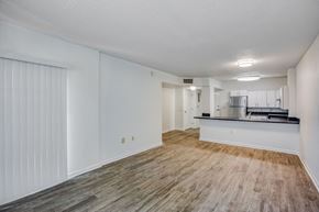 Miami apartment for rent - a living room with a kitchen in the background