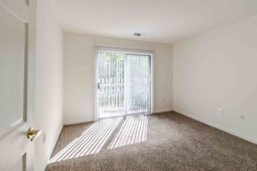 Colonial Heights apartment for rent - A room with a carpeted floor and a sliding glass door leading outside.