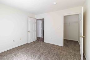 Colonial Heights apartment for rent - A room with a carpeted floor and two doors, one of which is open.