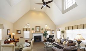 Woodbridge apartment for rent - A living room with a fireplace and a ceiling fan.at Summerland Heights Apartments, Woodbridge, VA