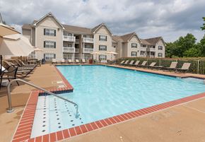 Woodbridge apartment for rent - A swimming pool with a red brick border and a building in the background at Summerland Heights Apartments, Woodbridge, 22191
