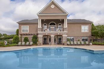Pool with clubhouse exterior