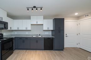 Greenville apartment for rent - A kitchen with black and white cabinets and a black dishwasher at Dunean Creek Apartments, Greenville, SC