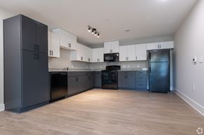 Greenville apartment for rent - A kitchen with black cabinets and a wooden floor at Dunean Creek Apartments, Greenville