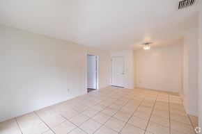 Homestead apartment for rent - A room with a tiled floor and two doors.