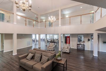 Fredericksburg apartment for rent - A large open living room with a couch and a chandelier.