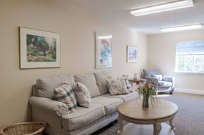 Fredericksburg apartment for rent - A living room with a couch, a coffee table, and two pictures on the wall.