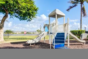 Palm Beach apartment for rent - A playground with a white tower structure and a blue slide.