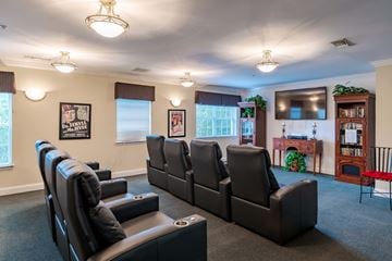 Manassas Park apartment for rent - A living room with black leather chairs and a grey carpet.