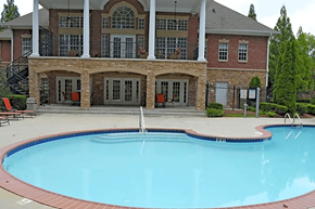 Lawrenceville apartment for rent - a swimming pool in front of a house with a resort style pool