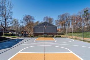 Mooresville apartment for rent - A basketball court with a basketball hoop and a basketball court building in the background.