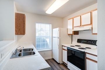 Manassas apartment for rent - A kitchen with a black oven and white countertops.